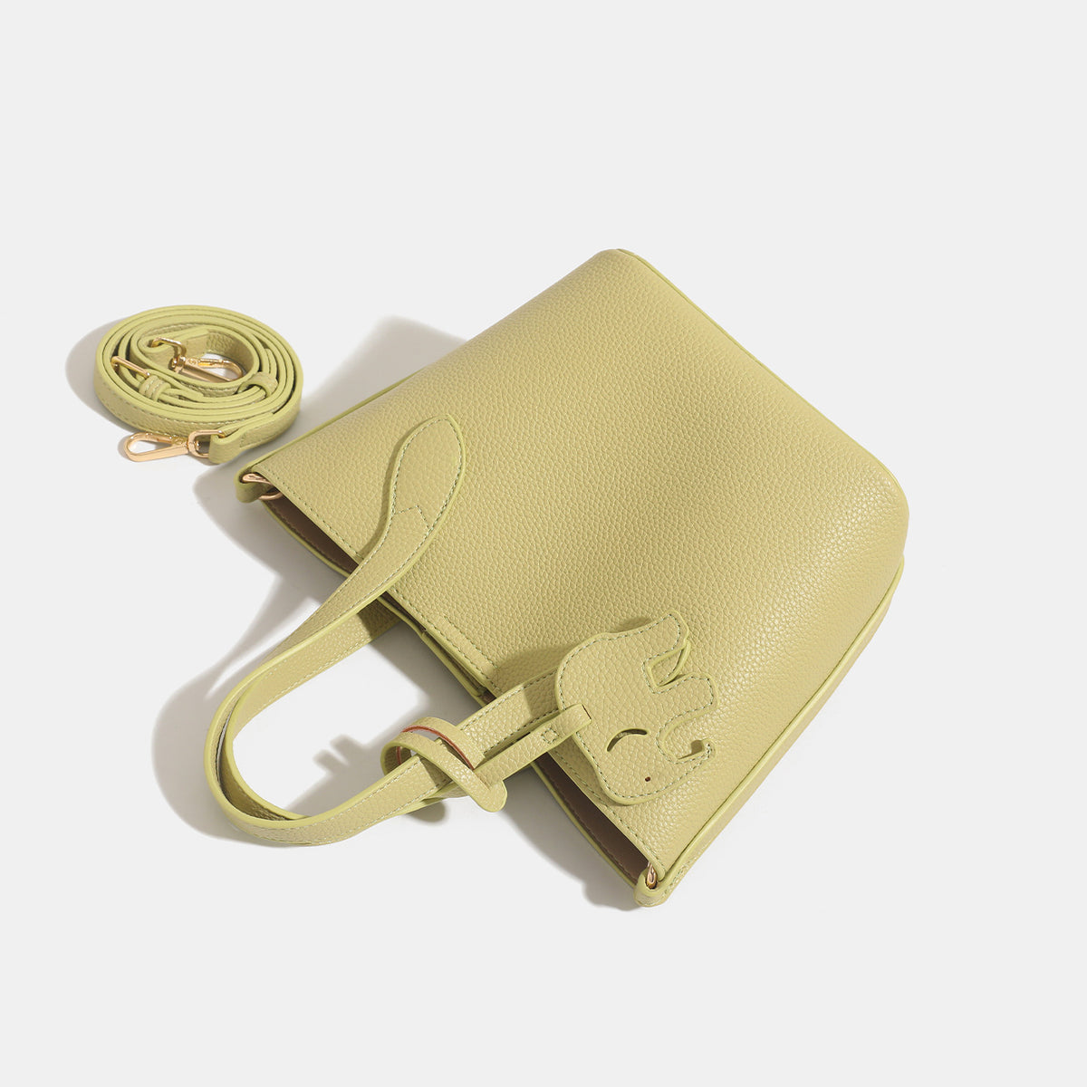 Pebbled leather-look bucket tote with elephant charm pendant, dual top handles, and detachable shoulder strap, detail view 4