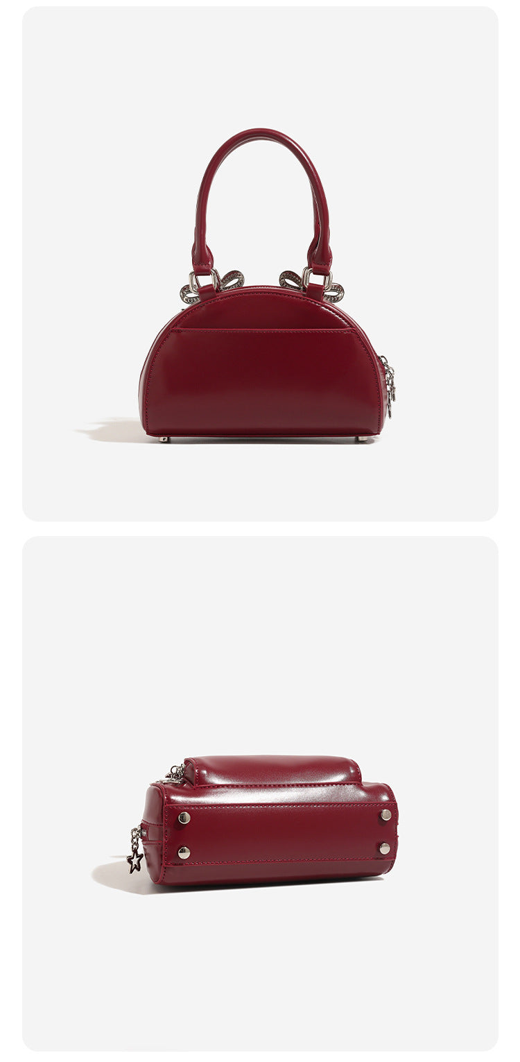 Structured half-moon mini handbag with silver-tone crystal bow hardware and star charm chain, detail view 11