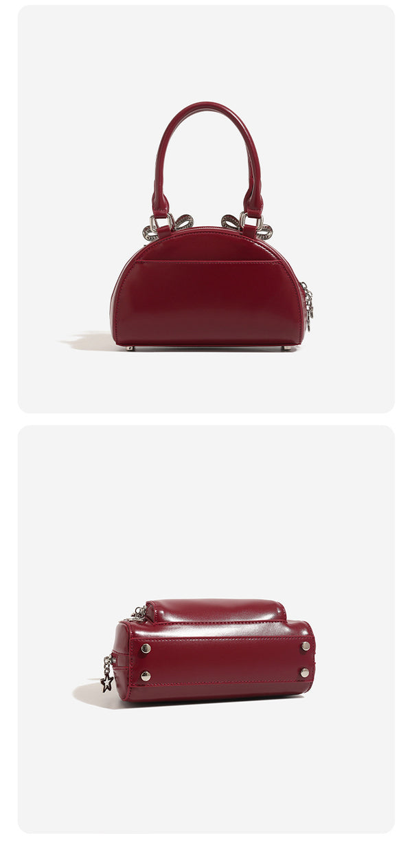Structured half-moon mini handbag with silver-tone crystal bow hardware and star charm chain, detail view 11