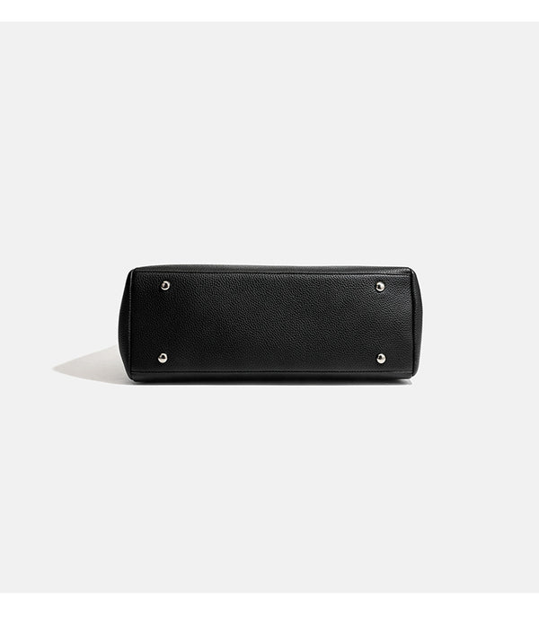 Structured black pebbled-finish flap tote bag with silver turn-lock clasp and long double shoulder straps, detail view 11