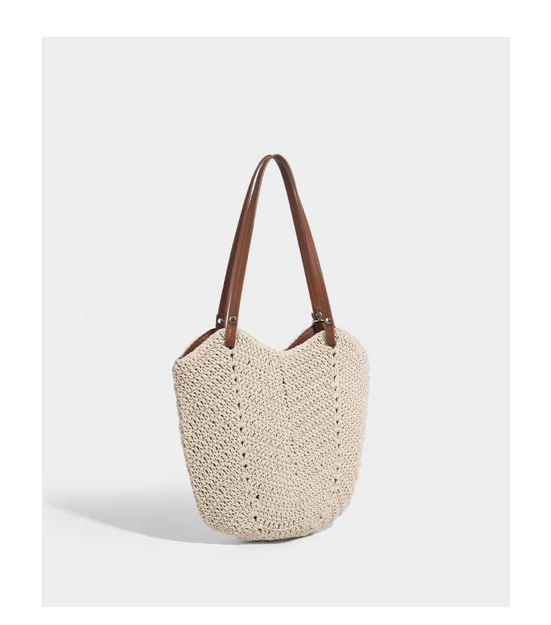 Woven crochet open-top shoulder tote bag with slim brown leather-look straps and braided charm accent, detail view 13