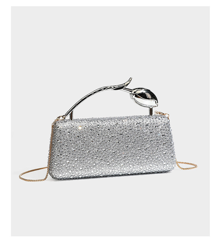 rectangular hard-case rhinestone evening clutch with sculptural gold-tone branch-and-bud top handle and detachable chain
