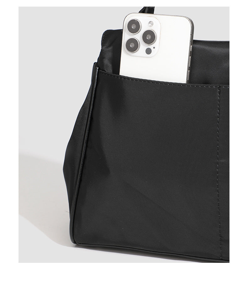 Structured black leather-look flap satchel bag with silver turn-lock hardware and top handle, detail view 32