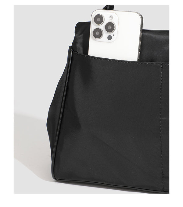Structured black leather-look flap satchel bag with silver turn-lock hardware and top handle, detail view 32