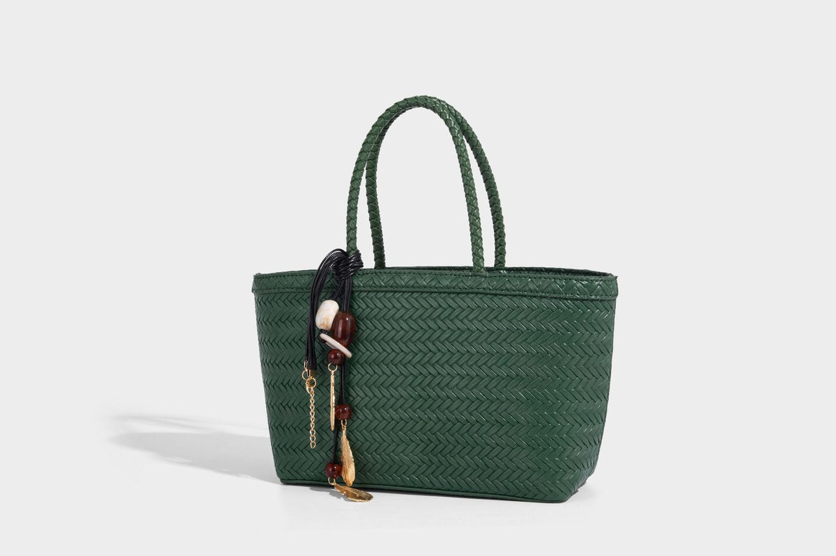 Structured chevron woven leather-look tote bag with braided top handles, gold feather charm, and adjustable shoulder strap