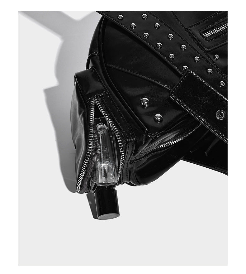 Glossy black crescent shoulder bag with silver-tone rivets, multiple zip pockets, and long adjustable studded straps, detail