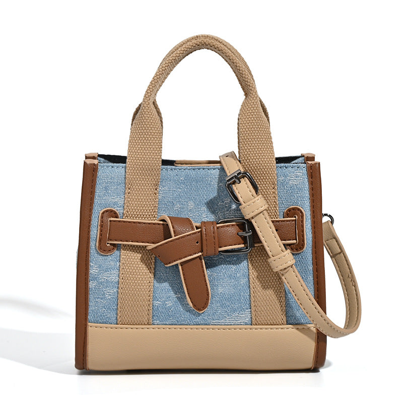 Structured mini tote bag in washed denim and neutral colorblock with brown leather-look trim and front belt buckle detail