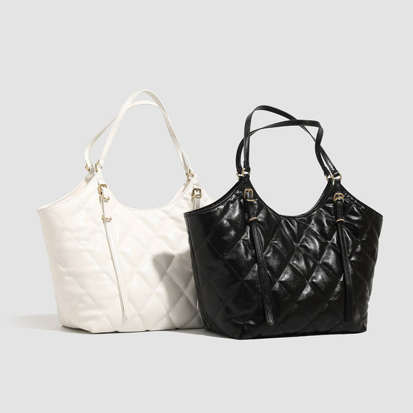 Large quilted diamond-pattern tote bag with glossy leather-look finish, dual flat shoulder straps, and gold-tone hardware