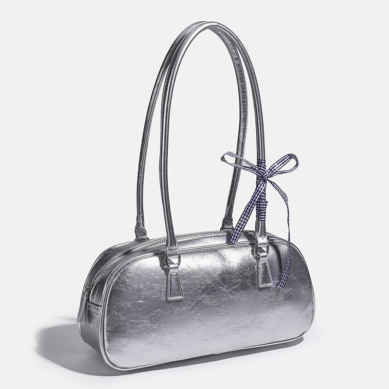 Rounded rectangular shoulder bag with glossy crinkled finish, dual long handles, top zip closure, and gingham ribbon bow
