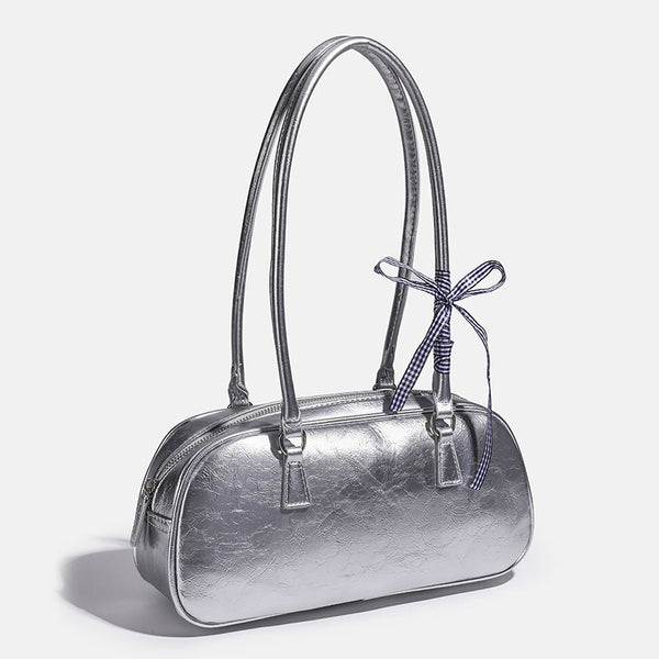 Rounded rectangular shoulder bag with glossy crinkled finish, dual long handles, top zip closure, and gingham ribbon bow