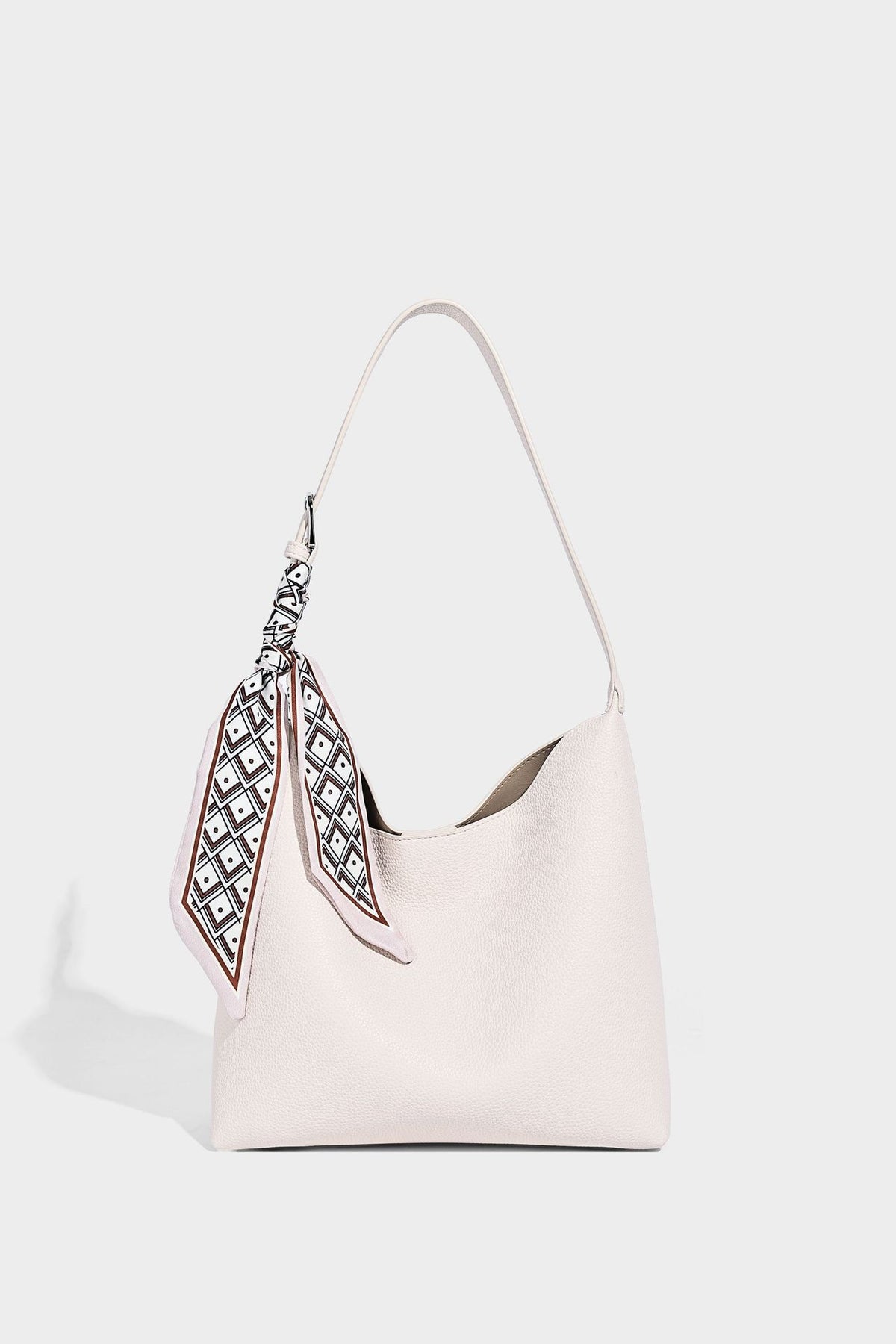 Soft slouchy hobo shoulder bag in pebbled matte finish with slim strap, silver-tone ring hardware, and knotted printed scarf