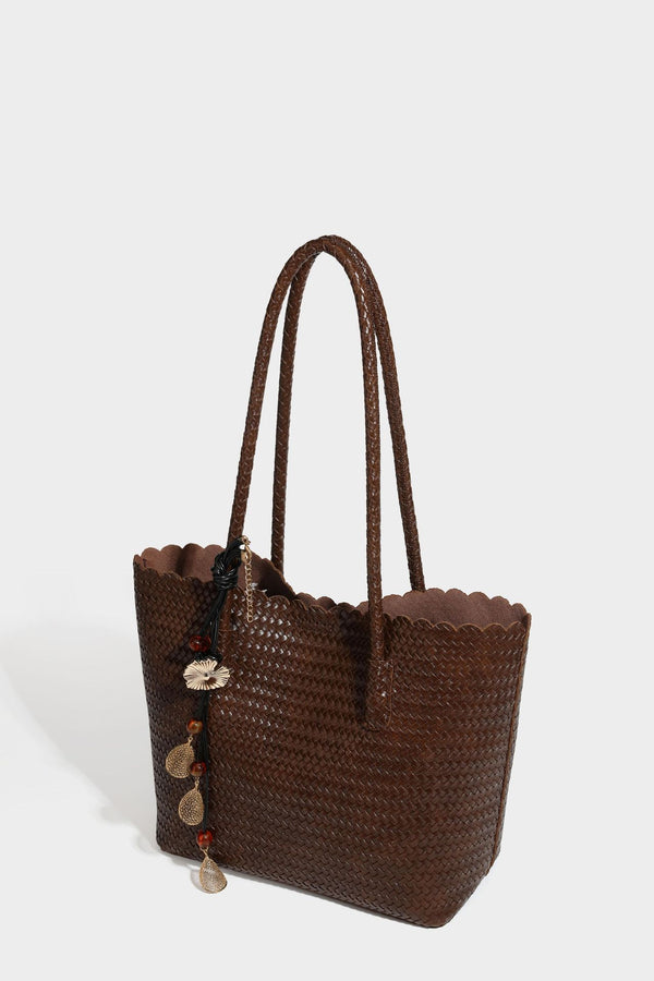 Large open-top woven leather-look tote bag in dark brown with scalloped edge, braided double shoulder straps, and decorative