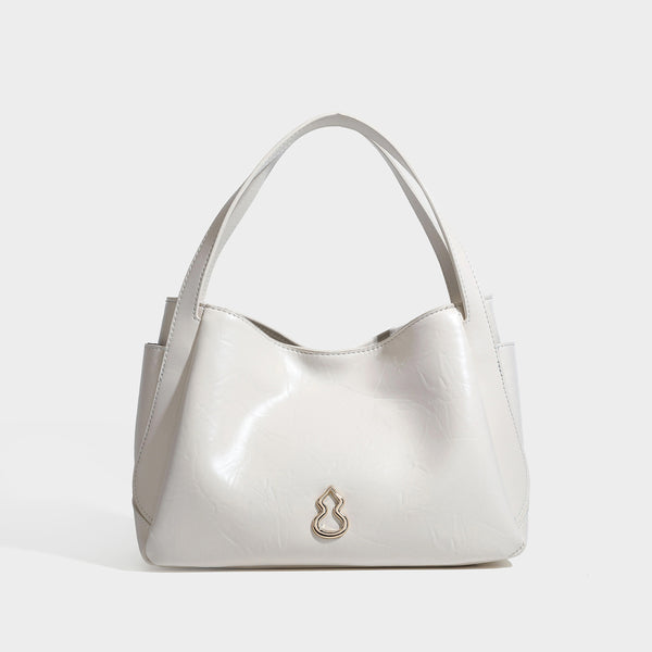 Black glossy crinkled leather-look convertible shoulder tote bag with gold gourd-shaped emblem hardware and detachable