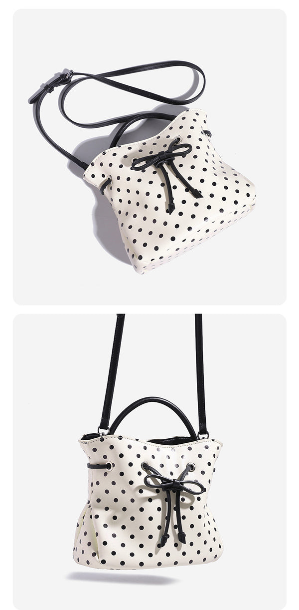 Compact polka-dot drawstring bucket bag with bow closure and rigid top handle, detail view 9